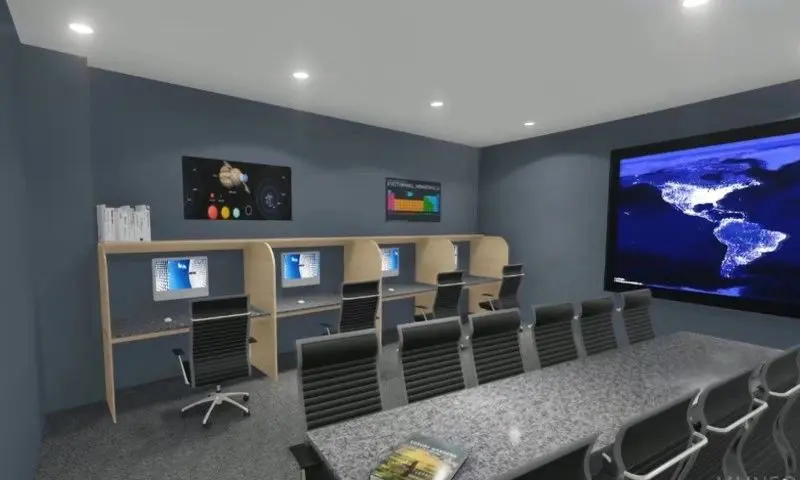 A computer room with many chairs and tables