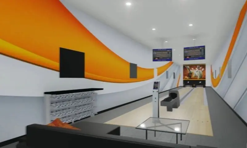A bowling alley with orange walls and white walls.